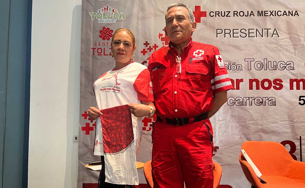 Foto del paramedico y de una señora enseñando la playera de la carrera de la Cruz Roja.
